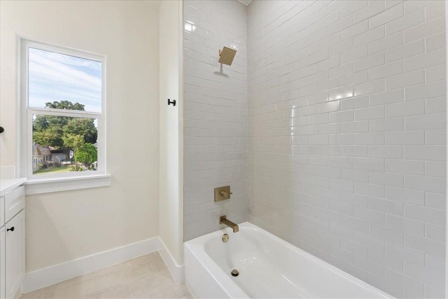 Full bathroom with tub / shower combination, vanity, and light tile patterned floors