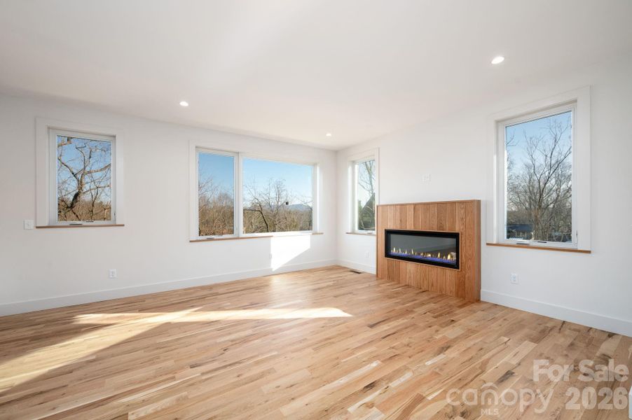 Spacious Living Room with Oversized Windows Framing Winter Mountain Views