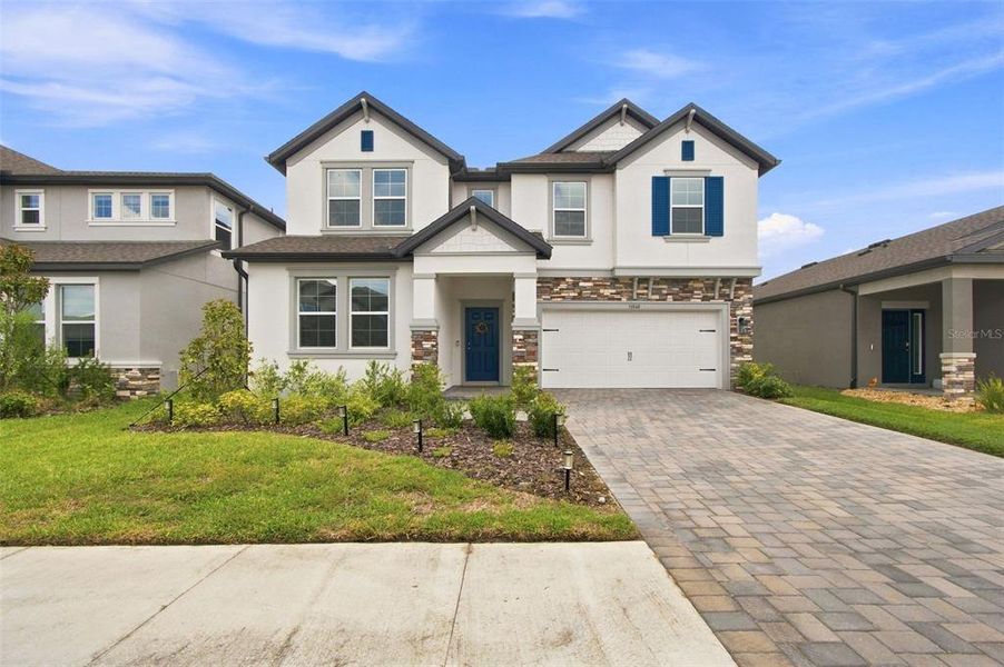 Front exterior of a new home in Epperson, Wesley Chapel, FL, highlighting curb appeal (Image 23). Front exterior of a new home in Epperson, Wesley Chapel, FL, highlighting curb appeal (Image 23).