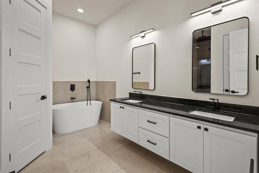 Bathroom featuring vanity and a bath