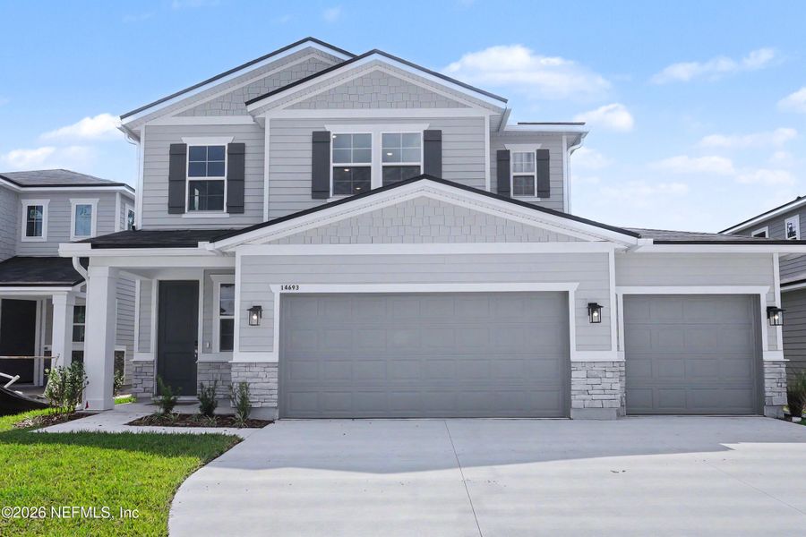 Front exterior of a new home in Aspen Trail, Jacksonville, FL, highlighting curb appeal (Image 24).