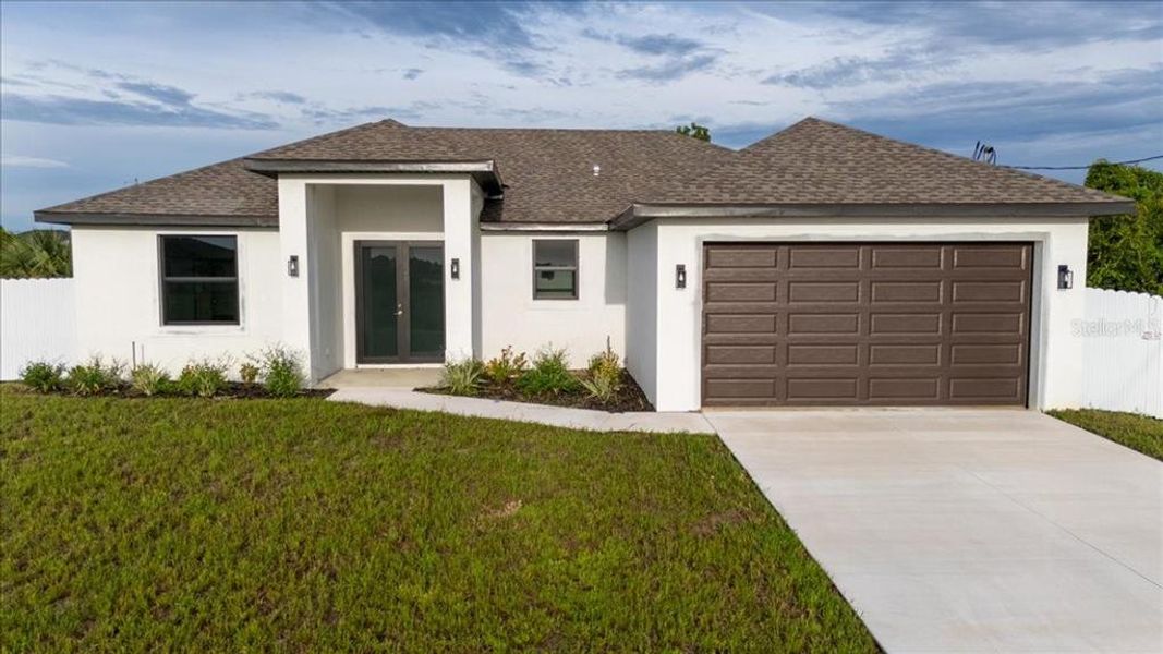 Front exterior of a new home in , Cape Coral, FL, highlighting curb appeal (Image 1). Front exterior of a new home in , Cape Coral, FL, highlighting curb appeal (Image 1).