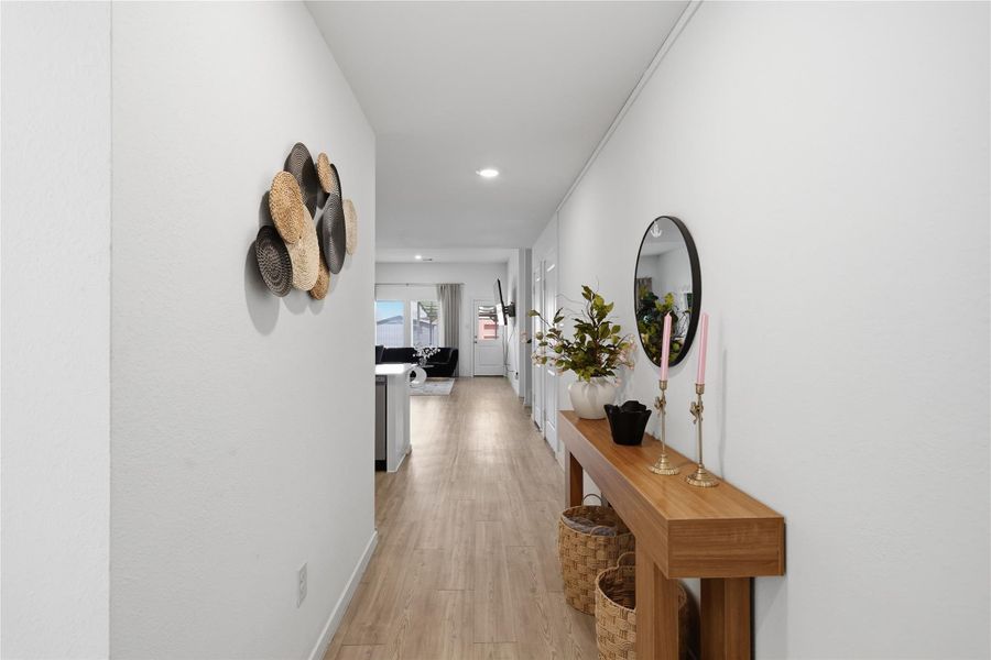 View from the front door towards the open concept kitchen, dining and living room.