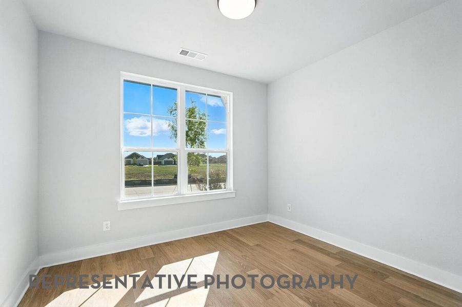 The study is bright and inviting, with windows that let in natural light, creating the perfect space to focus and work.