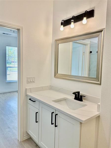 Bathroom featuring vanity and light wood-style floors