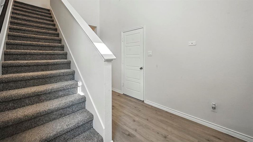 Stairway with baseboards and wood finished floors Stairway with baseboards and wood finished floors