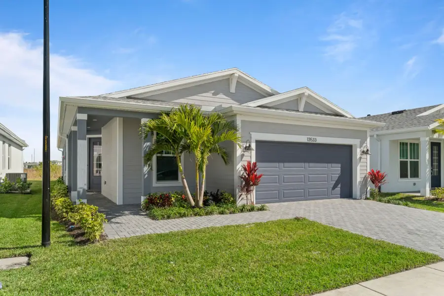 Front exterior of a new home in Tradition, Port St. Lucie, FL, highlighting curb appeal (Image 1). Front exterior of a new home in Tradition, Port St. Lucie, FL, highlighting curb appeal (Image 1).