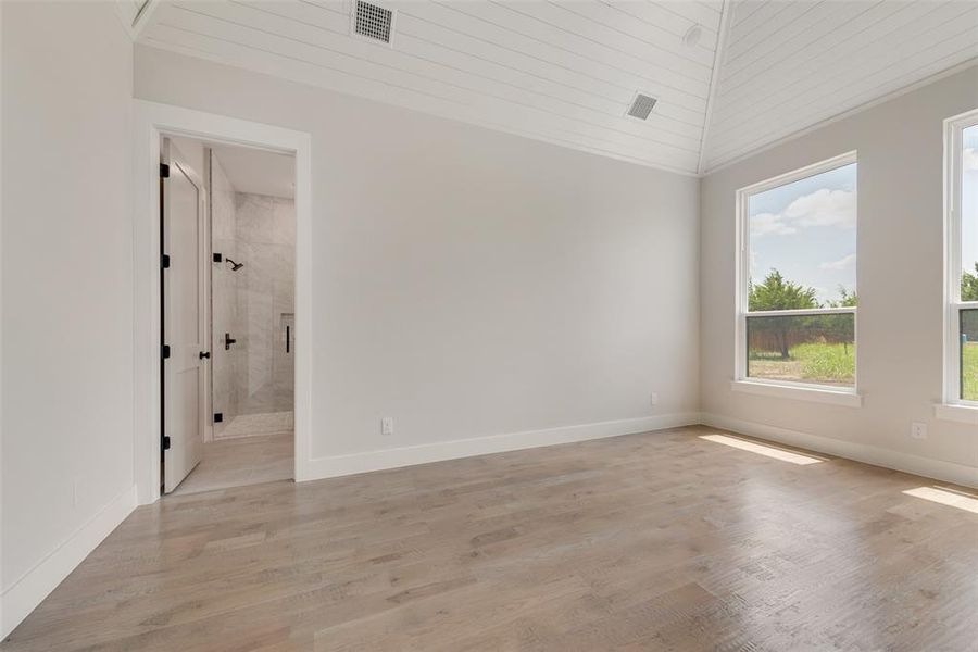 Spare room with light hardwood / wood-style floors, wooden ceiling, and vaulted ceiling