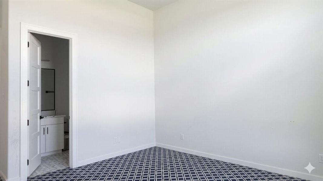 Room featuring geometric pattern carpet flooring