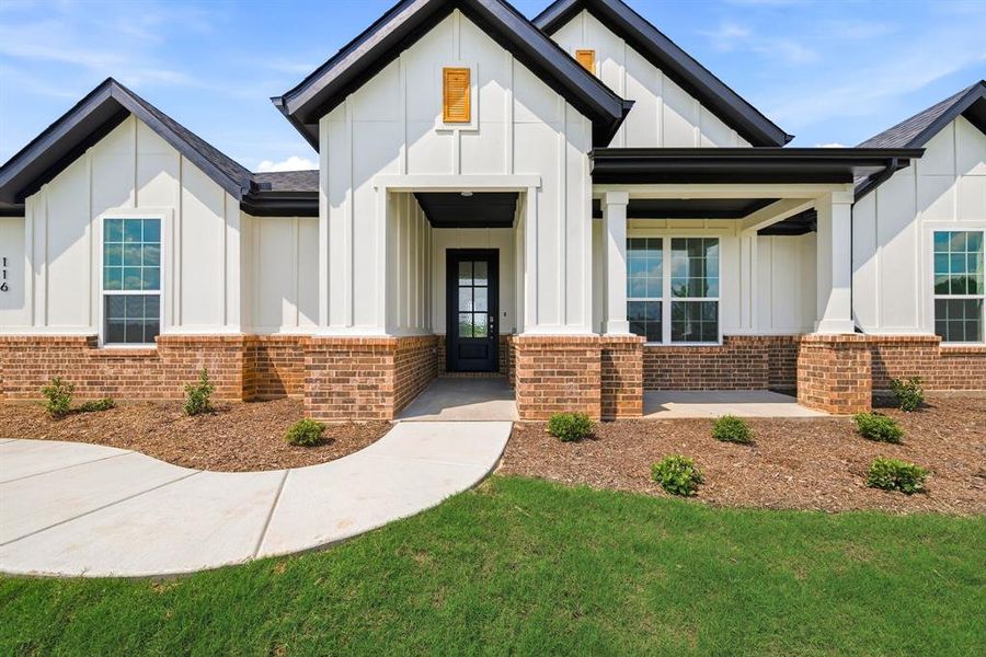 Front exterior of a new home in Saddleback Estates, Boyd, TX, highlighting curb appeal (Image 24). Front exterior of a new home in Saddleback Estates, Boyd, TX, highlighting curb appeal (Image 24).