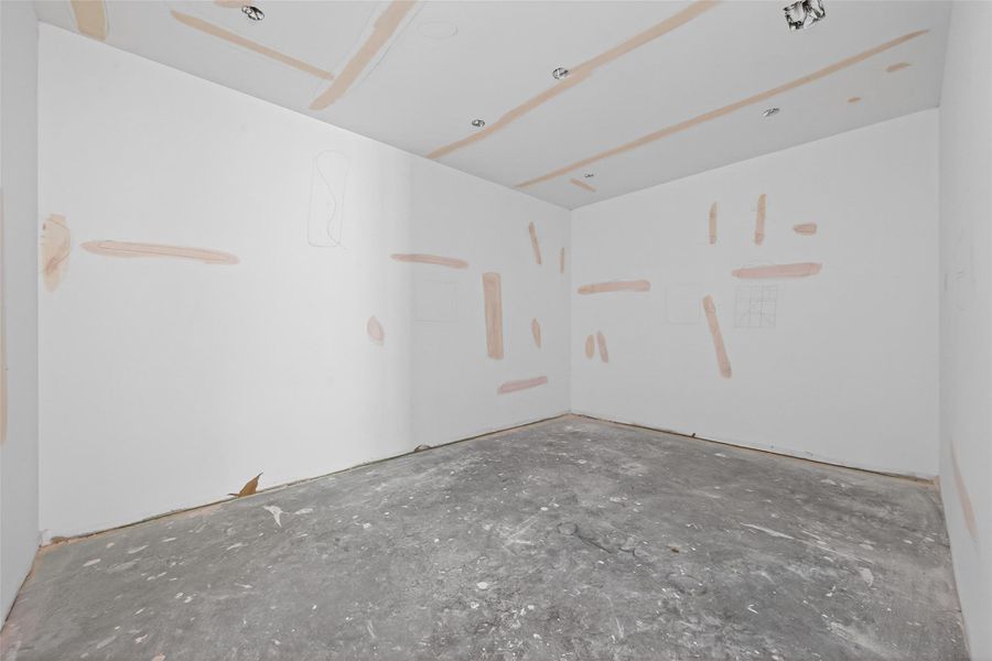 Ample space in the primary closet accessible through the bathroom. Island with drawers to be installed in the center