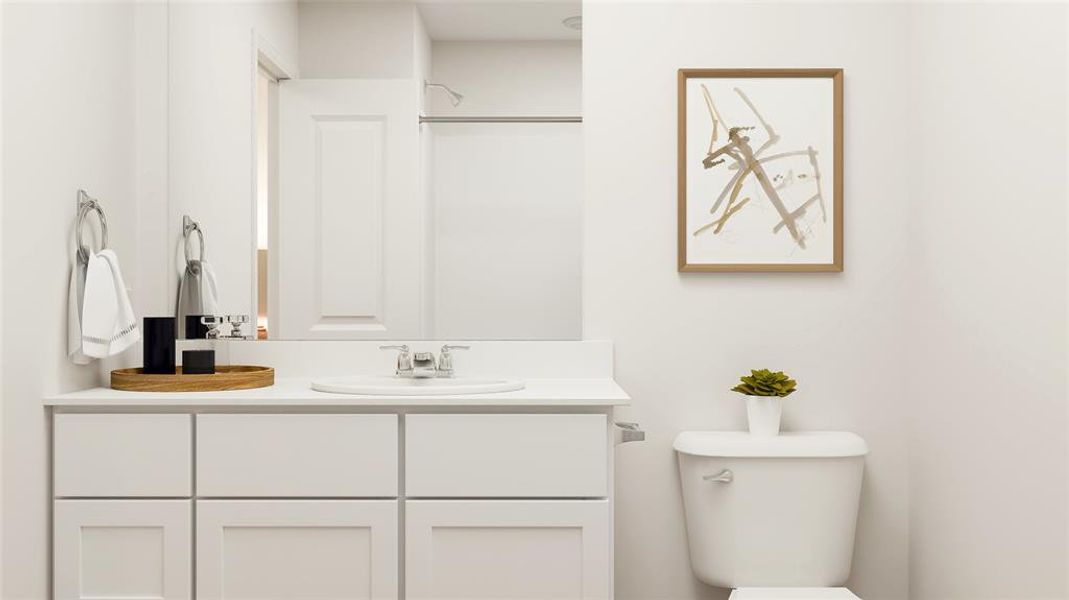 Bathroom featuring vanity and toilet