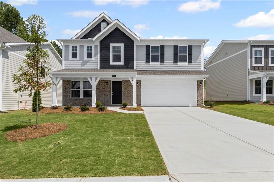 Front exterior of a new home in Sage Woods, Dallas, GA, highlighting curb appeal (Image 19). Front exterior of a new home in Sage Woods, Dallas, GA, highlighting curb appeal (Image 19).