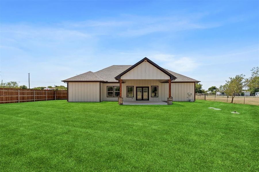 Back of house featuring a patio and a lawn