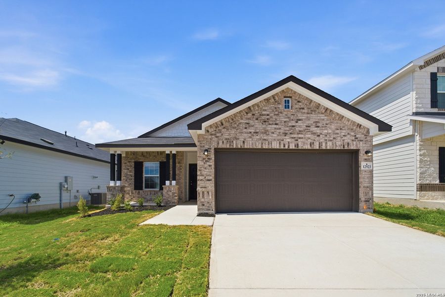 Front exterior of a new home in Mesa Vista, Von Ormy, TX, highlighting curb appeal (Image 19).