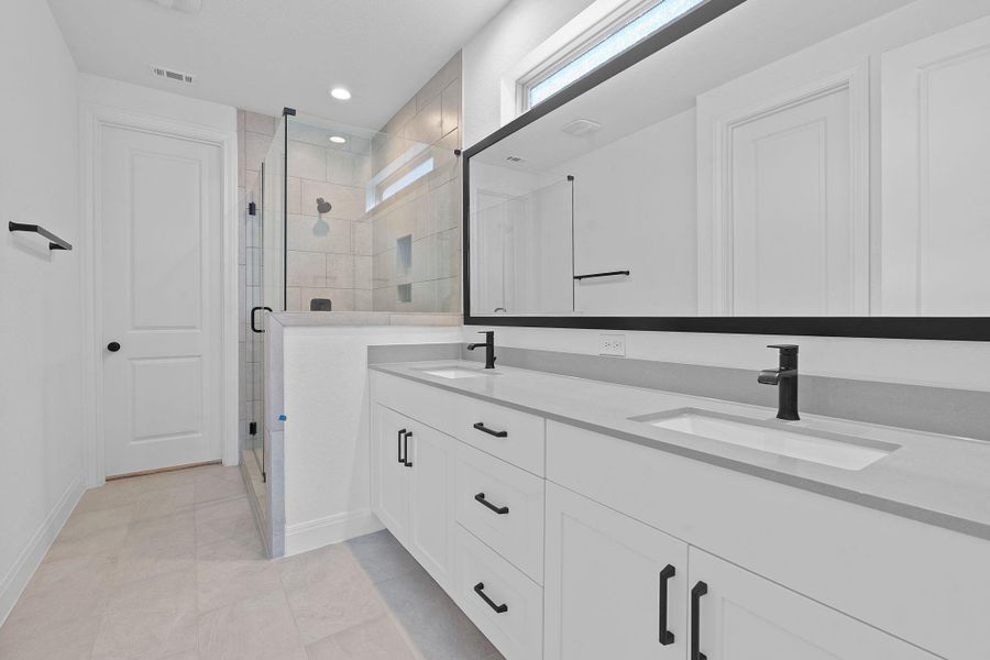 Bathroom featuring a shower stall, double vanity, light tile patterned flooring, and recessed lighting Bathroom featuring a shower stall, double vanity, light tile patterned flooring, and recessed lighting