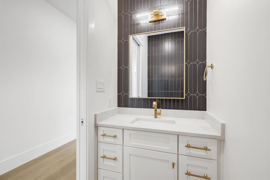 The upstairs powder room is the perfect place for a photo opportunity featuring an accent wall and pocket door.