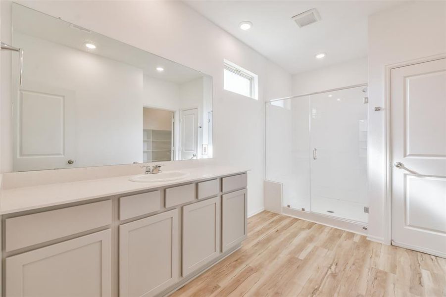 Beautiful en-suite bath with tiled shower and a built-in seat.