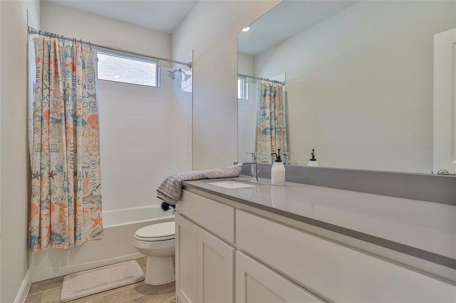 Bathroom featuring shower / tub combo and vanity Bathroom featuring shower / tub combo and vanity