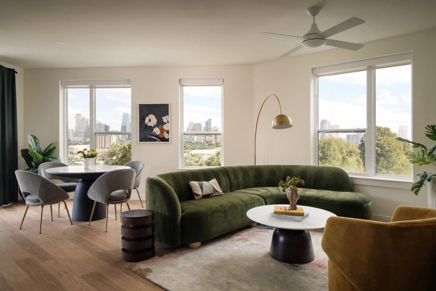 Generous windows frame panoramic city skyline views across this light-filled modern living space. Generous windows frame panoramic city skyline views across this light-filled modern living space.