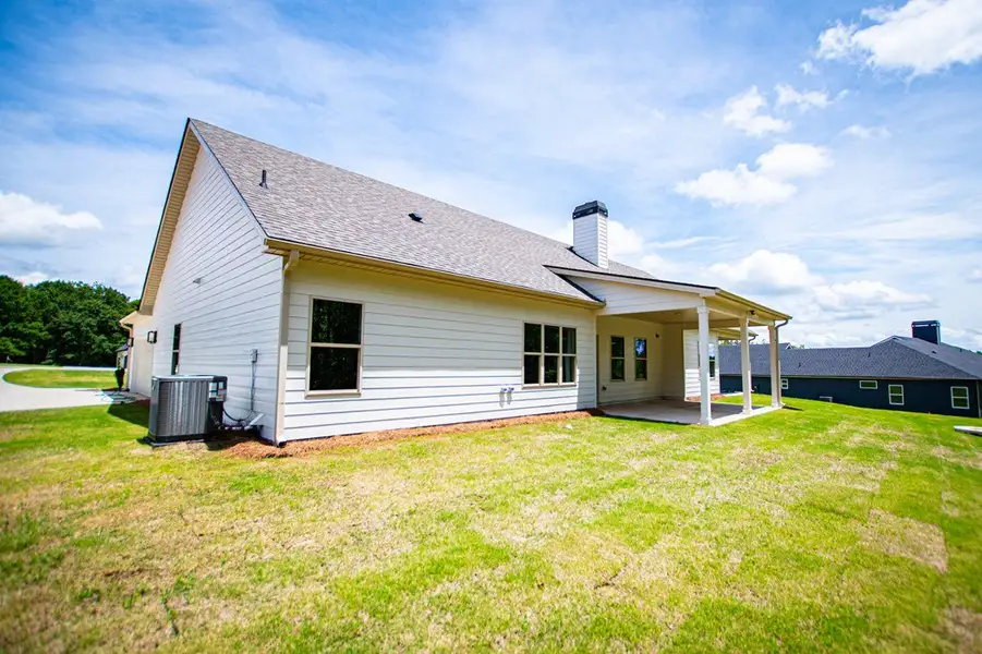 Exterior details and patio area of a home in WOODMONT RESERVE, Roopville (Image 3).