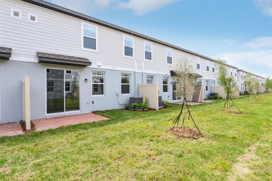 Exterior details and patio area of a home in The Meadow at Crossprairie Townes, St. Cloud (Image 24).