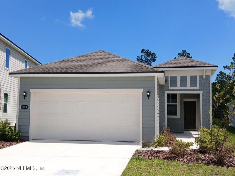 Front exterior of a new home in Palm Series at Seminole Palms, Palm Coast, FL, highlighting curb appeal (Image 19). Front exterior of a new home in Palm Series at Seminole Palms, Palm Coast, FL, highlighting curb appeal (Image 19).