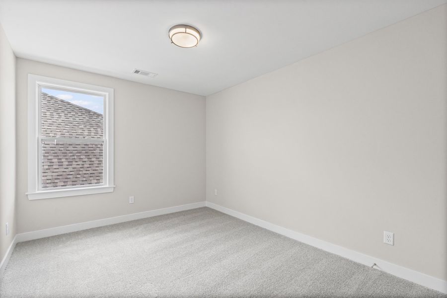Unfurnished room featuring light colored carpet and baseboards