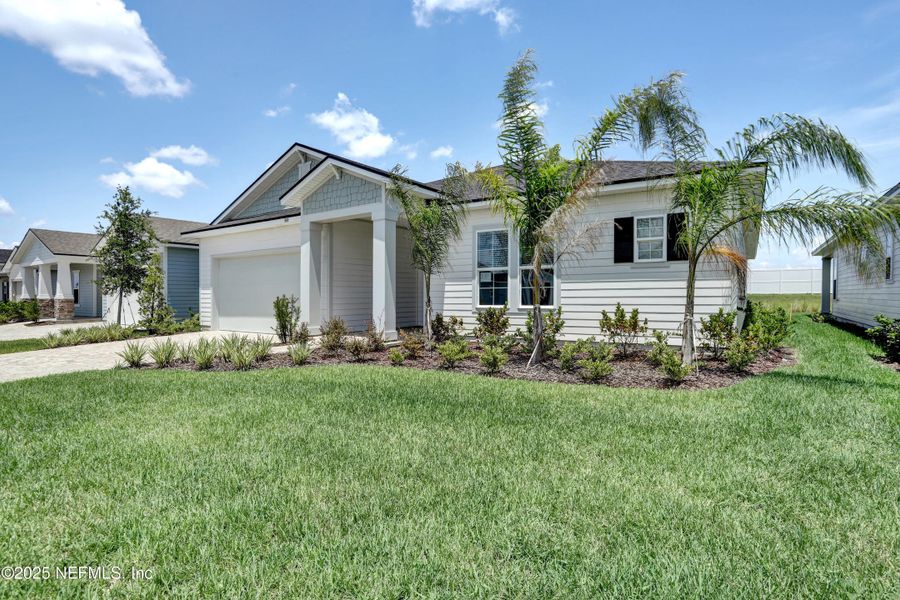 Front exterior of a new home in Reverie at Silverleaf, St. Augustine, FL, highlighting curb appeal (Image 1).