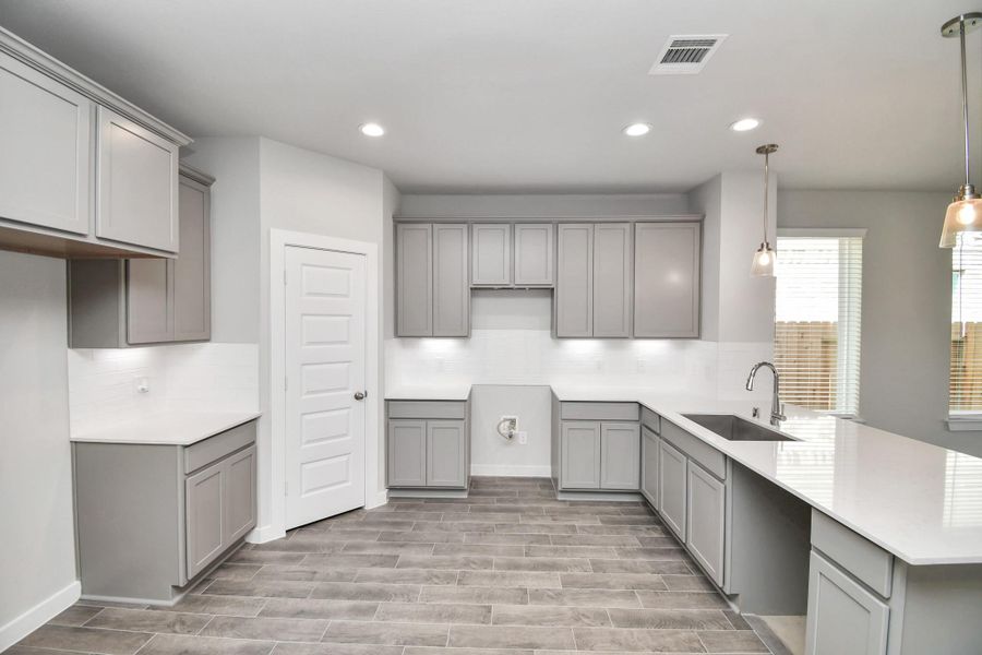 The kitchen is a culinary haven, featuring granite countertops, a tile backsplash, stainless steel appliances, 42” upper cabinets, and undercabinet lighting. The kitchen is a culinary haven, featuring granite countertops, a tile backsplash, stainless steel appliances, 42” upper cabinets, and undercabinet lighting.