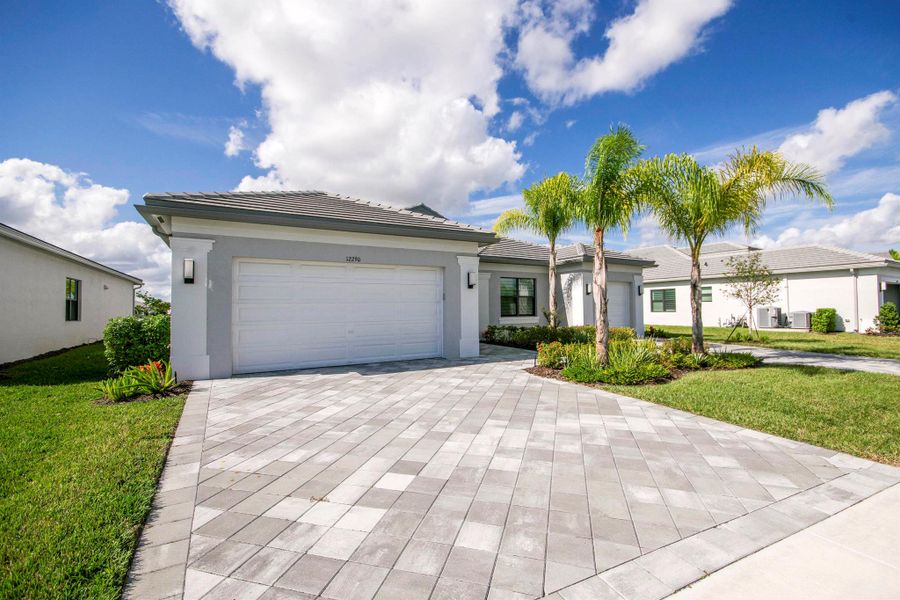Front exterior of a new home in , Port St. Lucie, FL, highlighting curb appeal (Image 21).