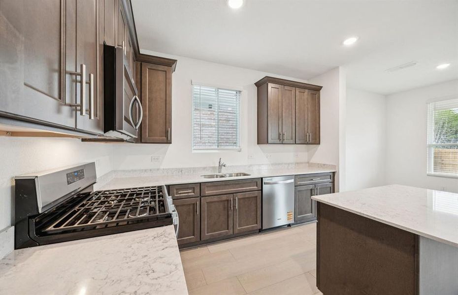 Kitchen overlooking gathering room and dining areas