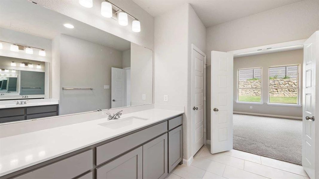 Bathroom with tile patterned flooring and vanity