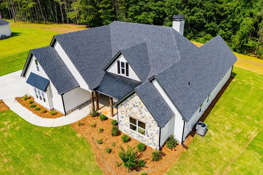 Front exterior of a new home in WOODMONT RESERVE, Roopville, GA, highlighting curb appeal (Image 36).