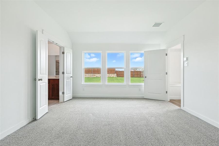 Unfurnished room with light carpet and baseboards