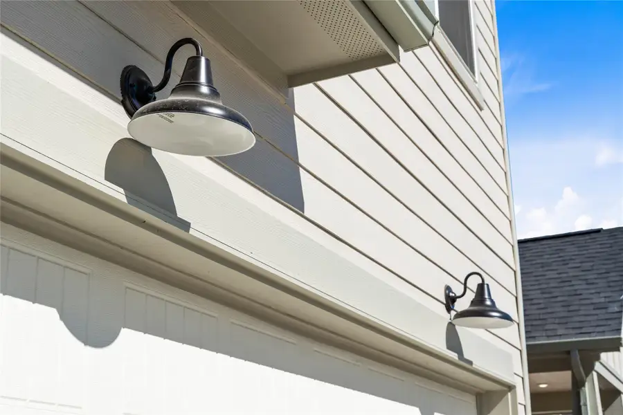 The property features stylish matte black gooseneck barn lights - providing ample illumination for safety and ambiance. The property features stylish matte black gooseneck barn lights - providing ample illumination for safety and ambiance.