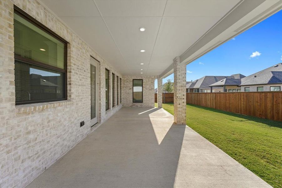 Fenced backyard with a patio area