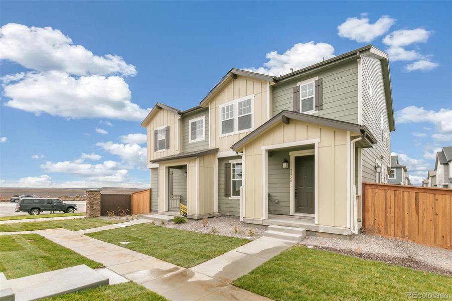 Front exterior of a new home in , Watkins, CO, highlighting curb appeal (Image 21).
