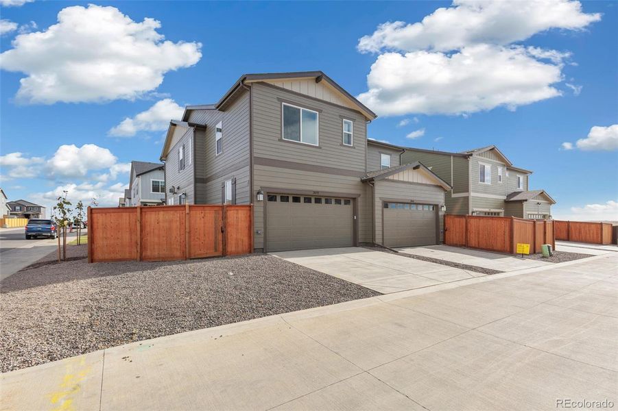 Front exterior of a new home in Sky Ranch Villas, Watkins, CO, highlighting curb appeal (Image 1). Front exterior of a new home in Sky Ranch Villas, Watkins, CO, highlighting curb appeal (Image 1).