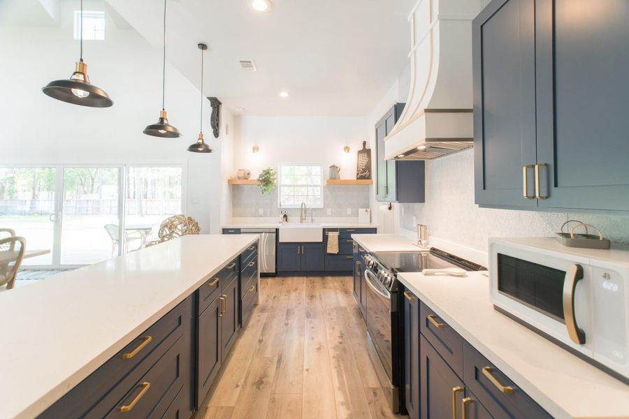 The home's open layout, high ceilings, and large windows create a bright, airy ambiance. The kitchen adds to the charm with chrome fixtures and elegant countertops. The home's open layout, high ceilings, and large windows create a bright, airy ambiance. The kitchen adds to the charm with chrome fixtures and elegant countertops.