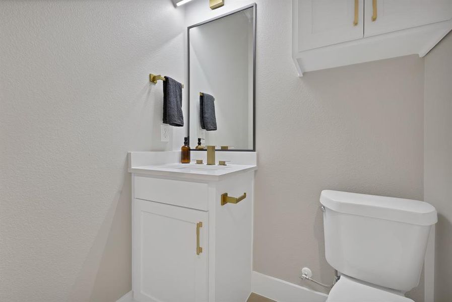 Half bath with vanity and toilet