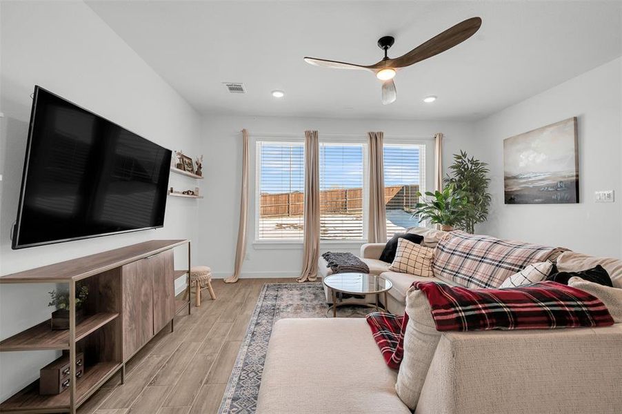 Living room featuring ceiling fan and light wood-type flooring