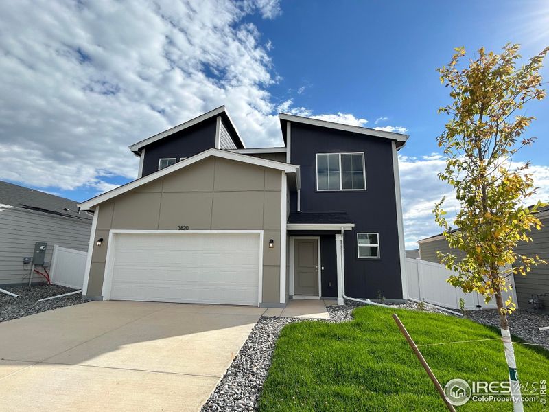 Front exterior of a new home in Liberty Draw, Evans, CO, highlighting curb appeal (Image 1).