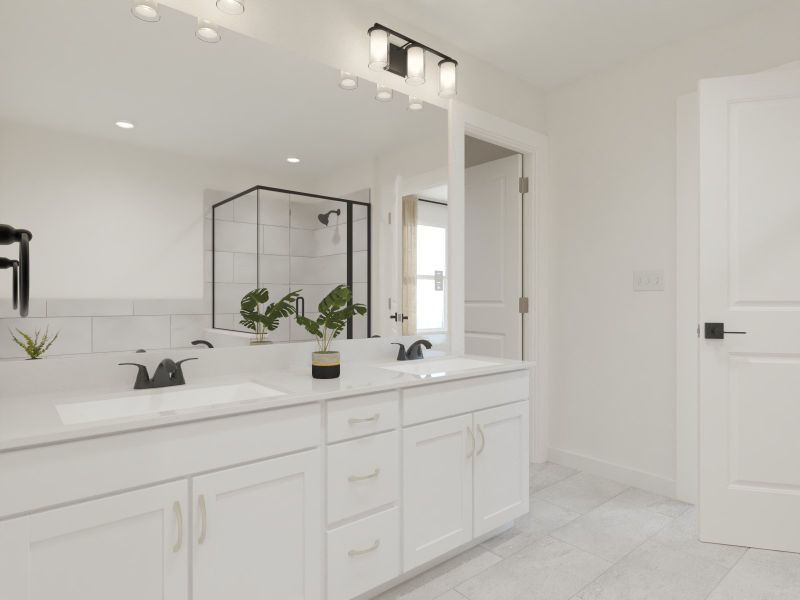 The primary bathroom offers dual vanity sinks and a walk-in shower.