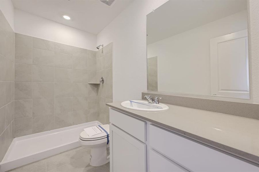 Primary bathroom featuring a large, tiled walk-in shower.