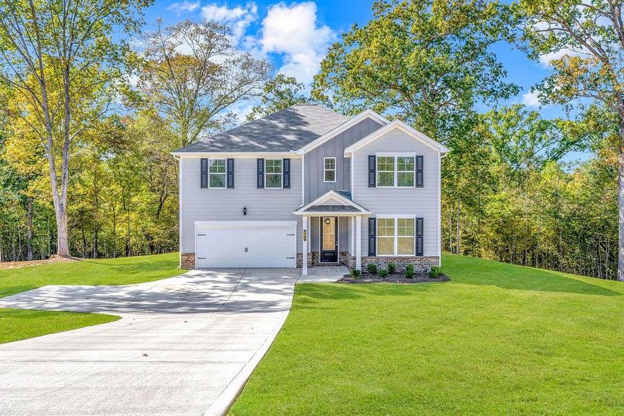 Front exterior of a new home in Waters Edge, Mansfield, GA, highlighting curb appeal (Image 2). Front exterior of a new home in Waters Edge, Mansfield, GA, highlighting curb appeal (Image 2).