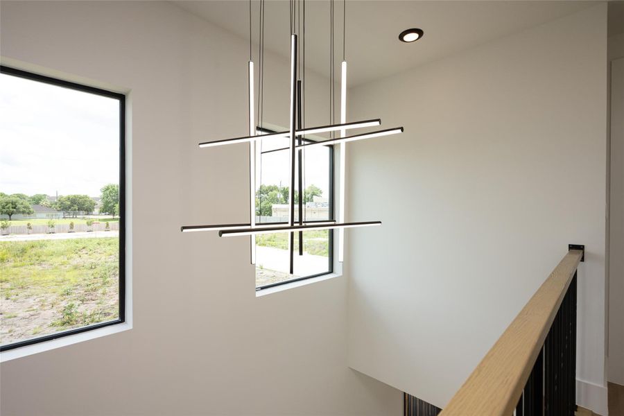 Modern chandeliers throughout the home provide continuity in design and illumination Modern chandeliers throughout the home provide continuity in design and illumination