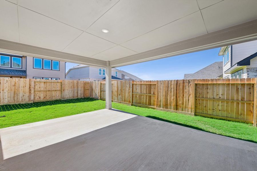 Relax on the covered patio in the backyard