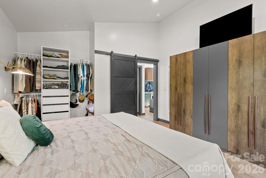 The owner's suite features ample storage with both an open closet and wardrobe cabinetry that conveys.