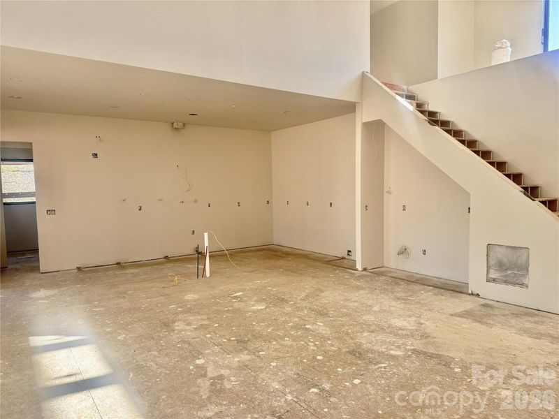 Kitchen featuring an adjacent dry bar and open staircase leading to the second-story loft, enhancing the home’s open-concept design. Kitchen featuring an adjacent dry bar and open staircase leading to the second-story loft, enhancing the home’s open-concept design.